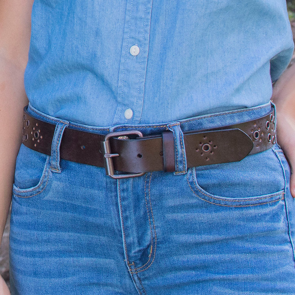 Women's Grommet Brown Leather Belt on model. Casual style, complementary to jeans
