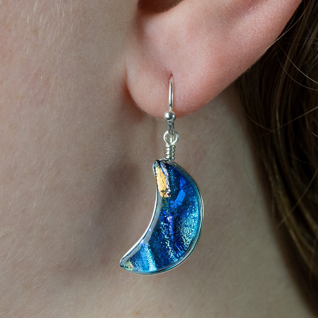 Blue Moon Earrings on a model showing mostly blue and silver colors. Approximately 1.5 inches long. 