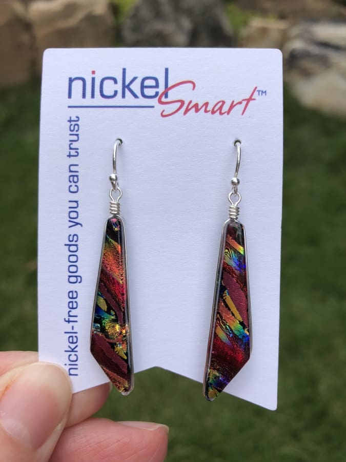 Red dichroic glass in shape of scalene triangle with tinges of blue and yellow. Cascades Earrings 