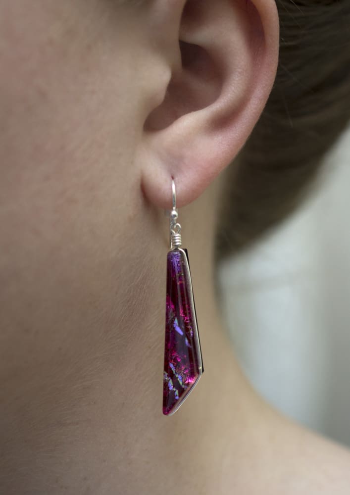 1.75 inch drop earrings made from pink dichroic glass with hints of red and other colors. 