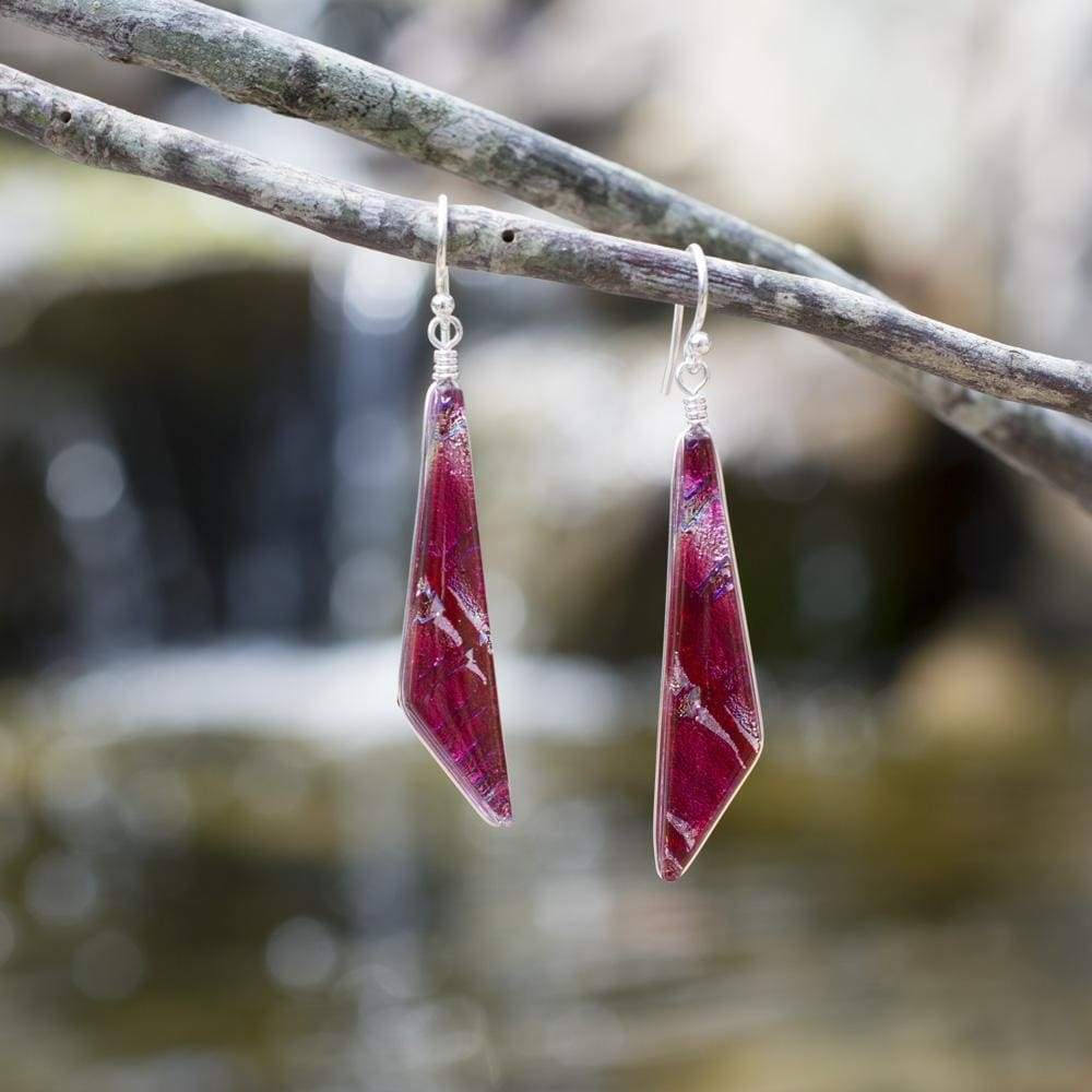Cranberry red dichroic glass in comet shape, with hints of other colors including pink. French hook