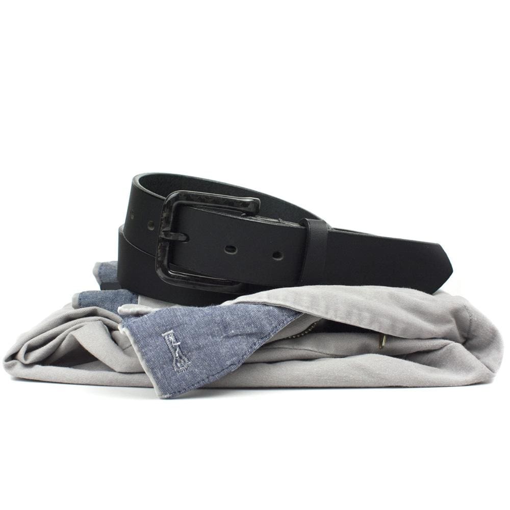 Image of The Specialist black leather belt sitting on pants.  black leather with black buckle.