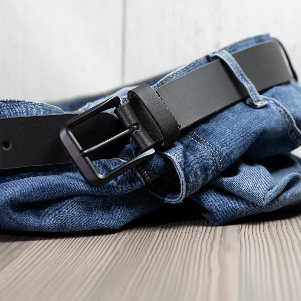 Black Mountain Belt looped through crumpled jeans. All-black style