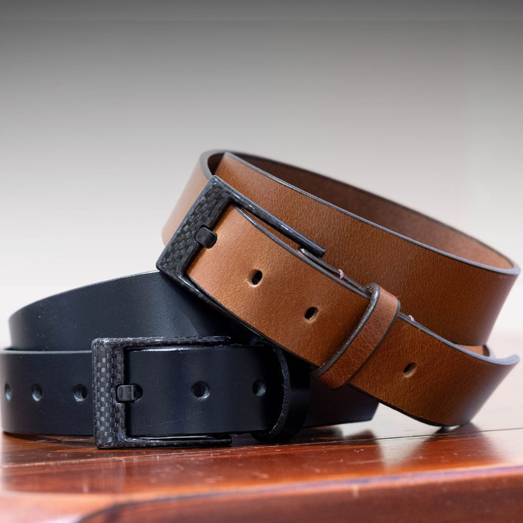 A black and brown belt with the same style of black carbon fiber buckle. Metal-free belt set.