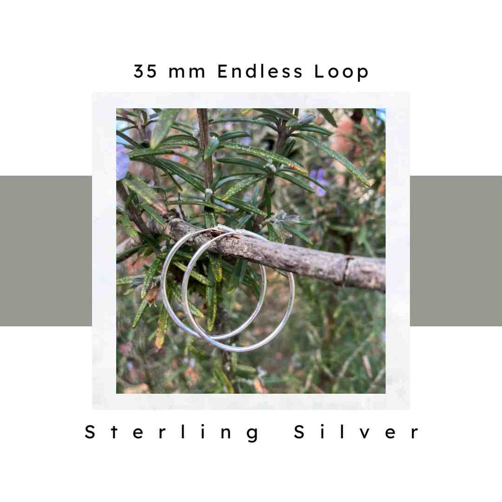 35 mm sterling silver hoop earrings pictured on a tree branch. Endless loop closure.