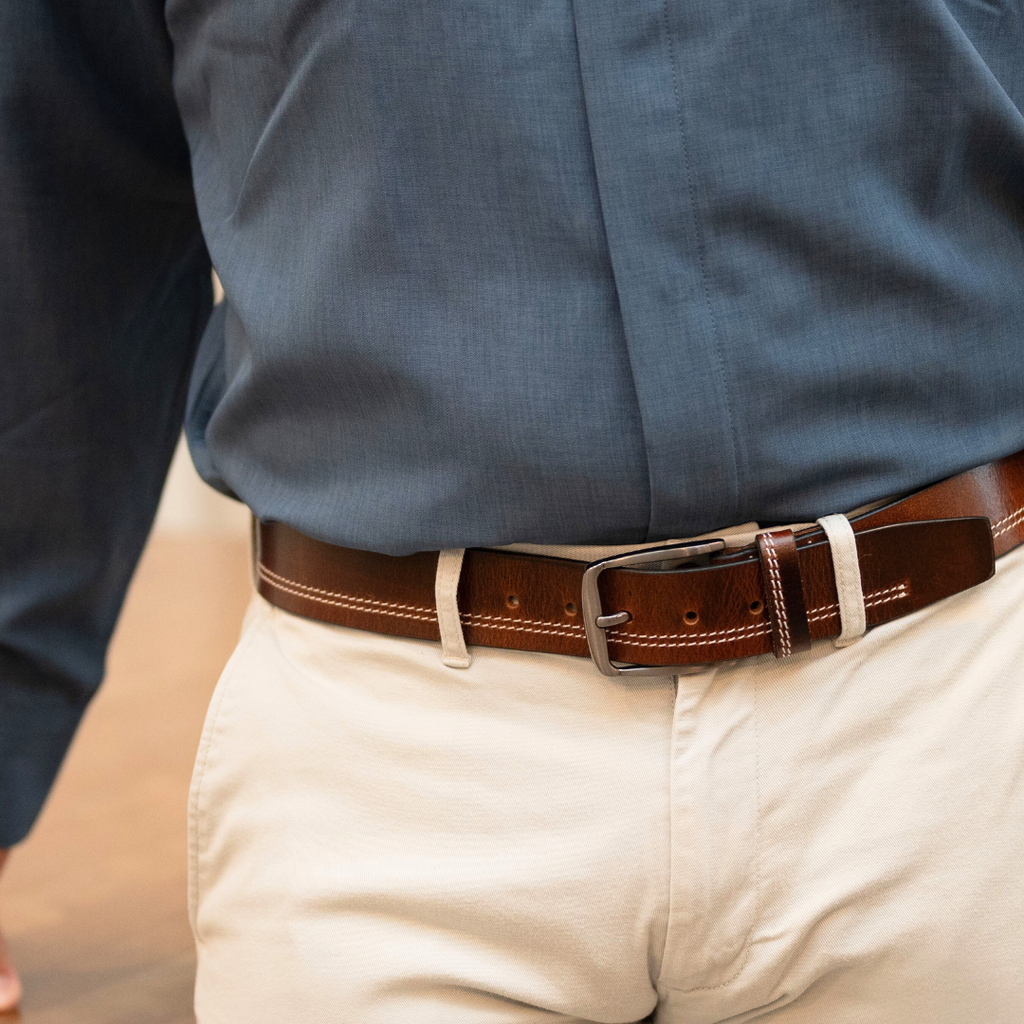 Brown Leather Belt on model with 2 rows of cream colored stitching. medium brown leather