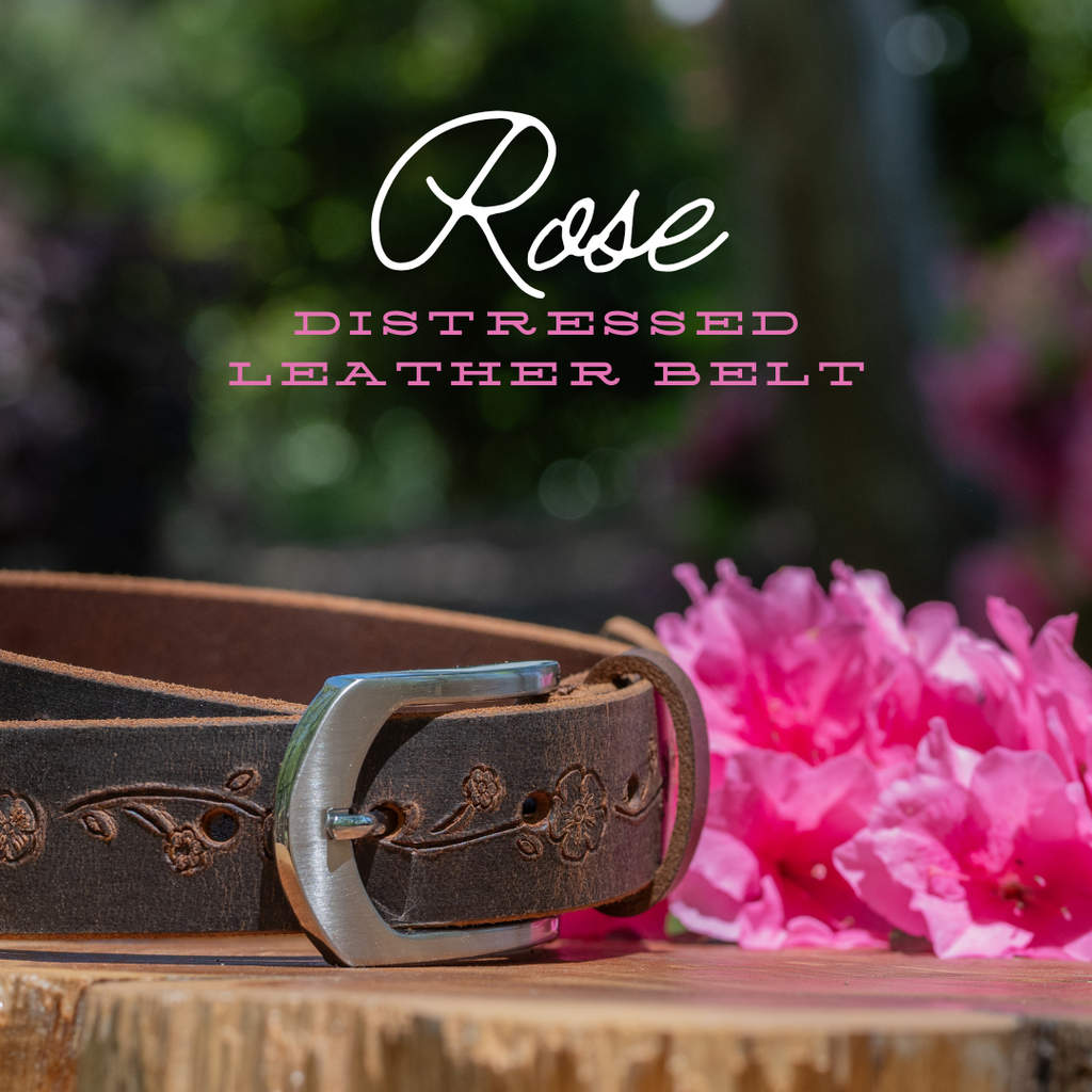 Distressed Rose Leather Belt on wood round with pink azalea in background. Nickel Free buckle. USA