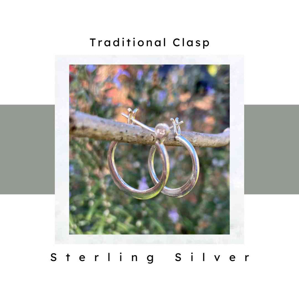 20 mm sterling silver hoop earrings pictured on a tree branch. Traditional back closure.