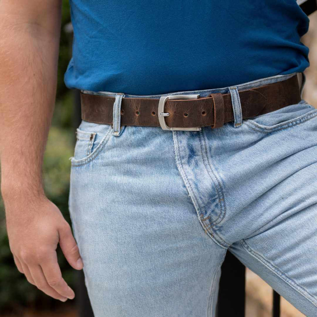 Silver, curved low profile buckle for sleek design with 1.5 inch distressed brown leather belt