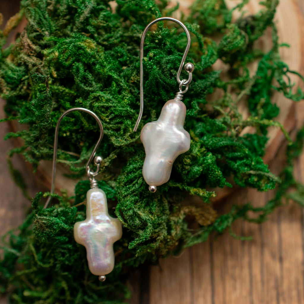 Morning Glory Freshwater Pearl Cross Earrings | Subtle cross-shaped pearls on French hooks on a bed of moss