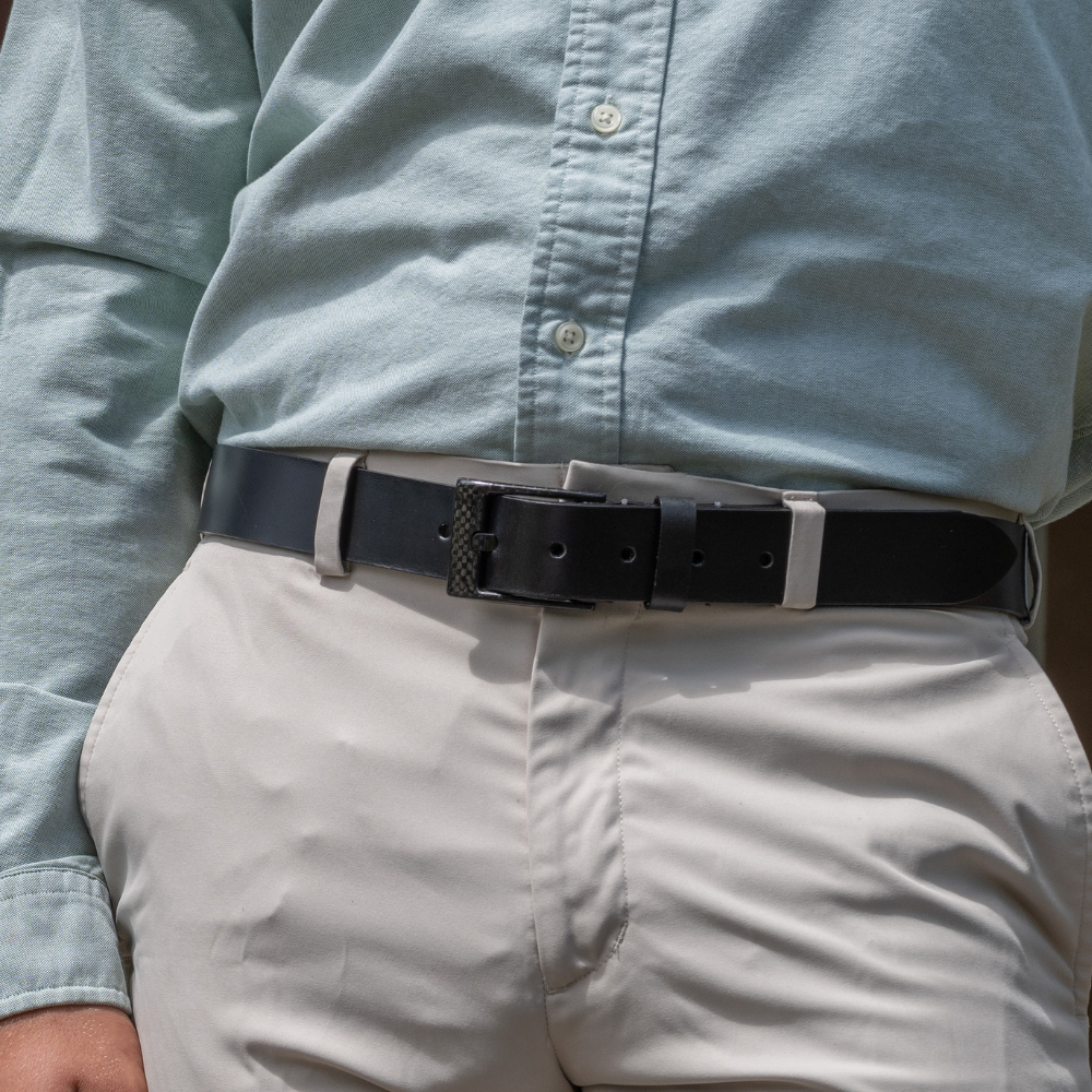Black Leather belt with black carbon fiber buckle.  1⅜ inches or 35 mm wide. No Metal Belt. 