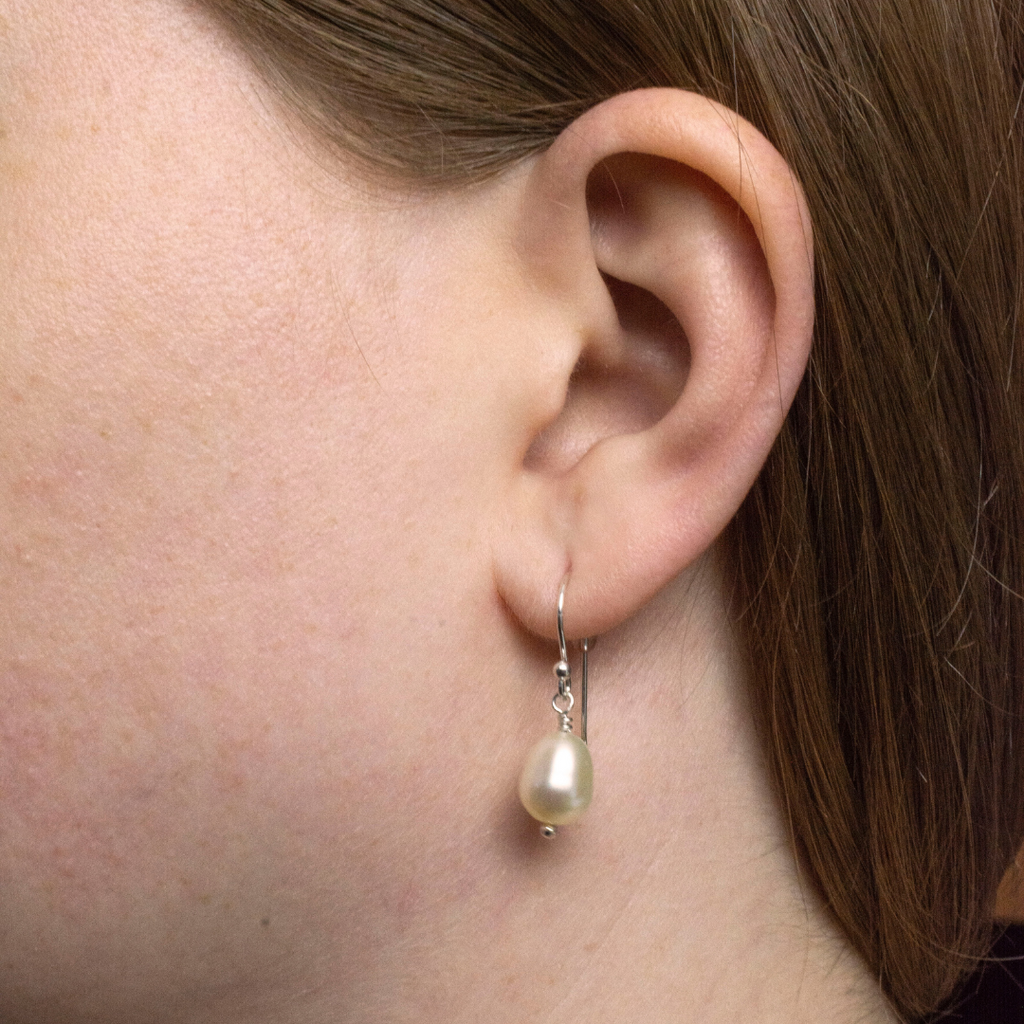 White Oval freshwater pearls. Dangle design. 1 pearl per earring. Pearl is approx. 10 mm in size.