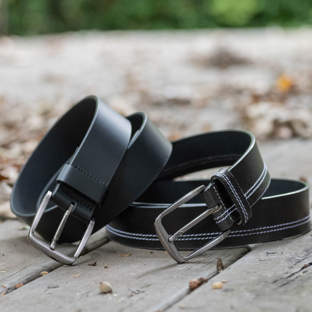 Millennial Black and Black Stitched Leather Belt Set. Outdoor setting. Glossy black leather straps.