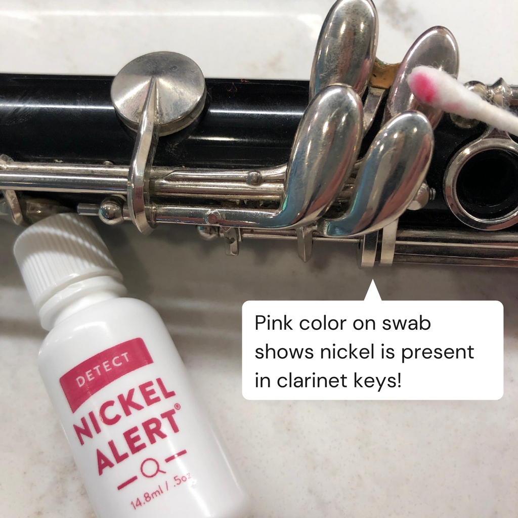 Testing the keys on a clarinet.  Pink color on swab shows nickel is present in clarinet keys.
