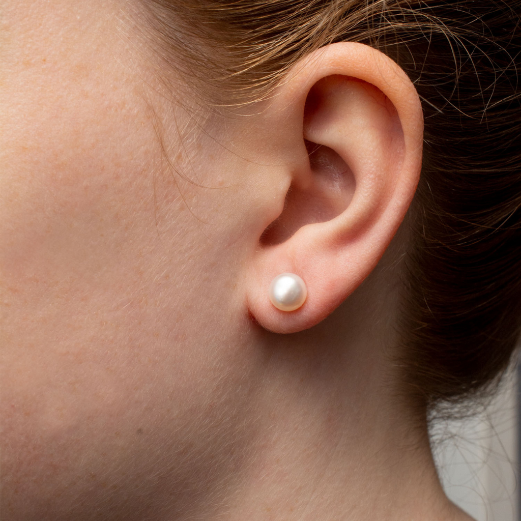Magnolia Freshwater Pearl Post Earrings on a model. Classic pearl stud earrings.