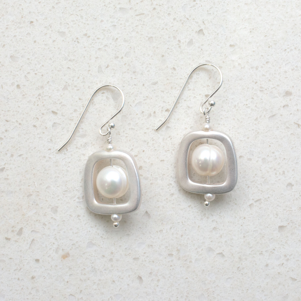 1 round white freshwater pearl with silver squarish frame. dangle earring. Nickel free French hook.