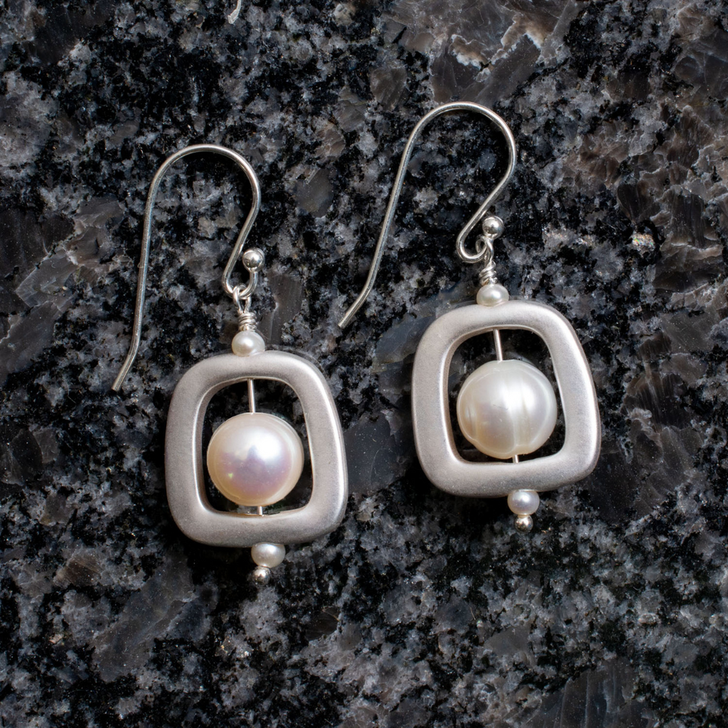 White freshwater pearls encased in geometric design. Dangle earring approx. length 1.5 inches.
