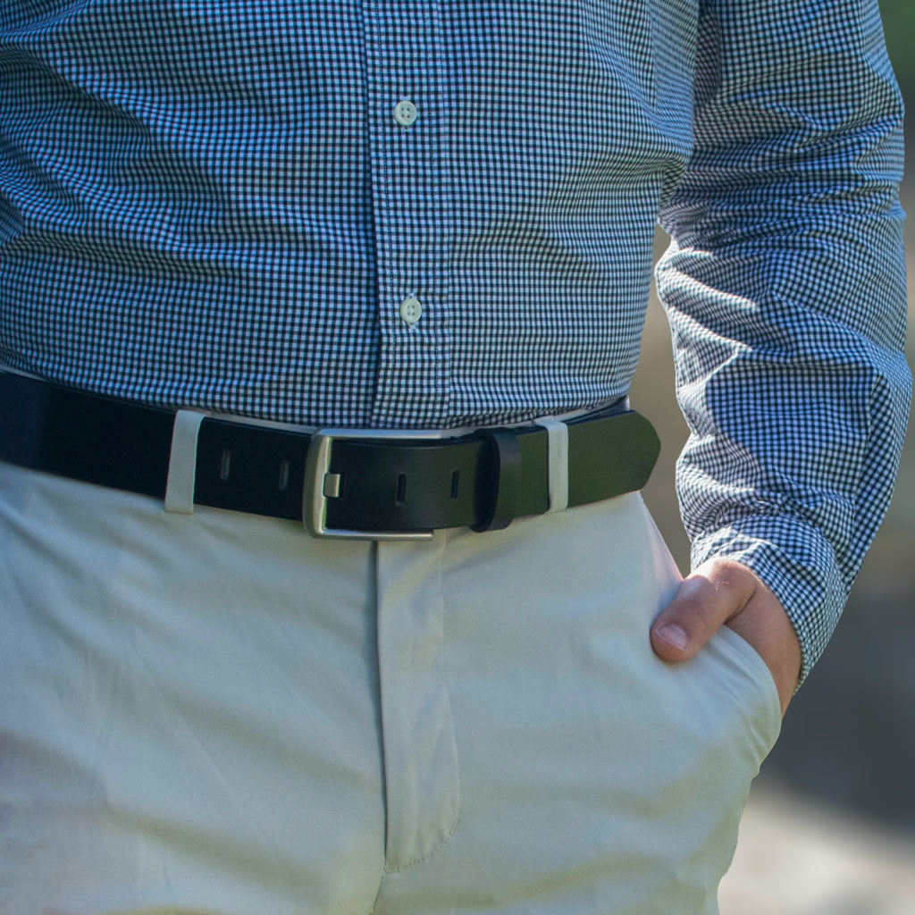 Titanium Wide Pin Black Belt on a model. Casual to dress-casual, paired here with khakis.