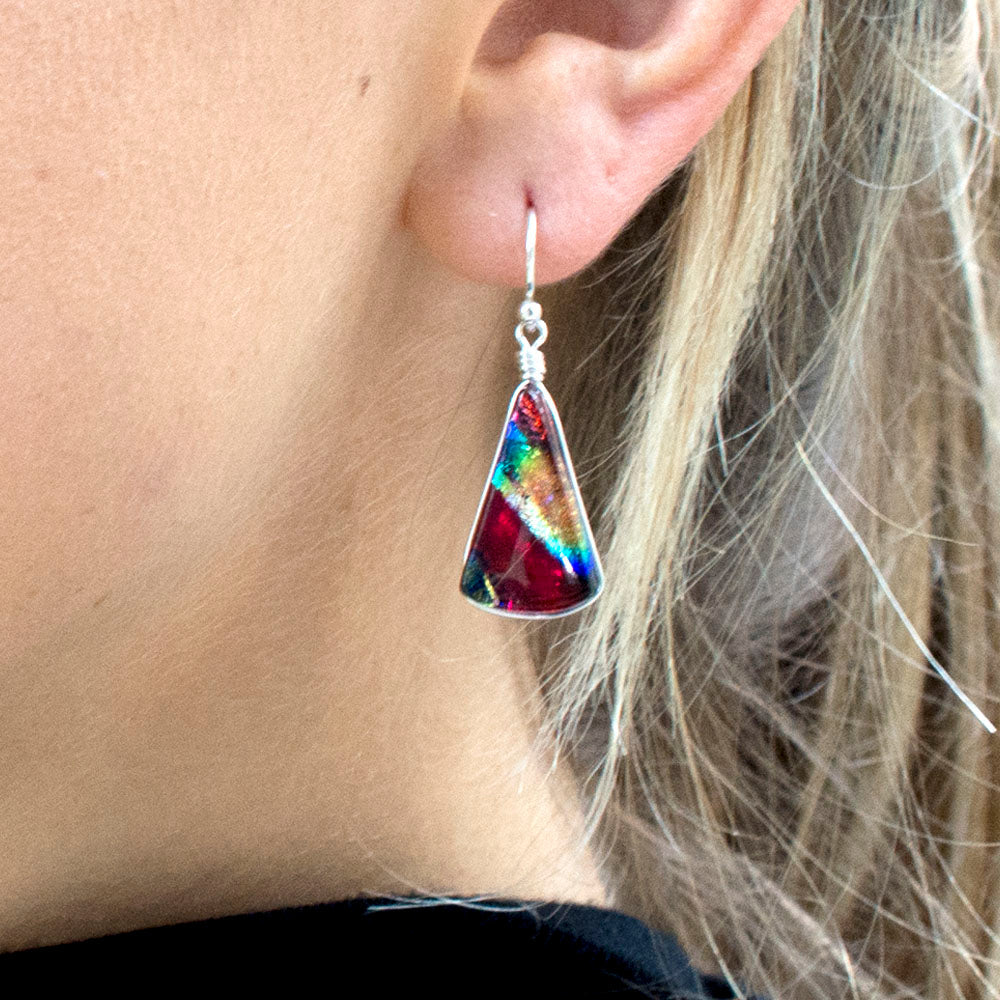 red dichroic glass earrings have blue, yellow and orange. fan shaped with silver French hook.
